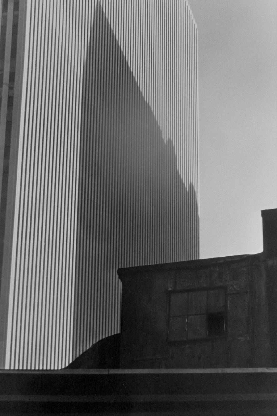 Louis Stettner, Old rooftop and new building from Broadway, Midtown, New York, 1985